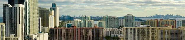 A panoramic view of a modern cityscape featuring a variety of buildings, including residential apartments, office towers, and industrial warehouses. The image captures the diverse nature of REIT investments.