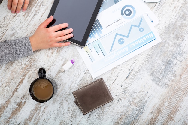 A close-up of a person's hands analyzing financial statements on a desk, with charts and graphs visible in the background, highlighting the importance of detailed financial analysis in REIT due diligence.