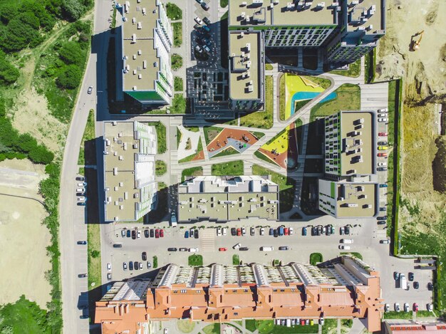 An aerial view showcasing a REIT's diverse property portfolio, including office buildings, residential apartments, retail centers, and industrial warehouses, highlighting the different types of real estate assets REITs can hold.