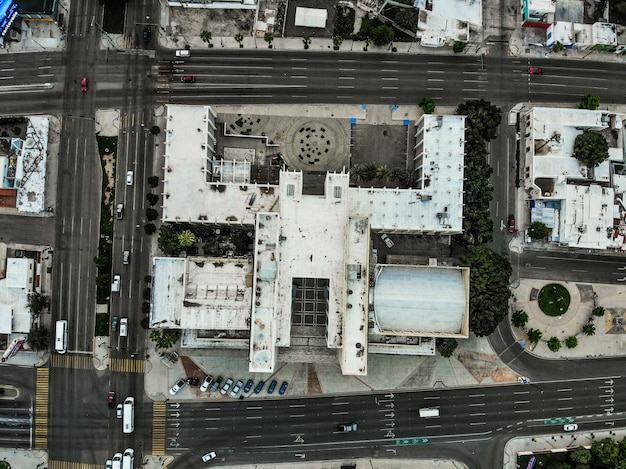 An aerial view of a diverse portfolio of commercial properties, including office buildings, retail centers, and residential complexes, all managed by a single REIT, showcasing the breadth of their asset management responsibilities.