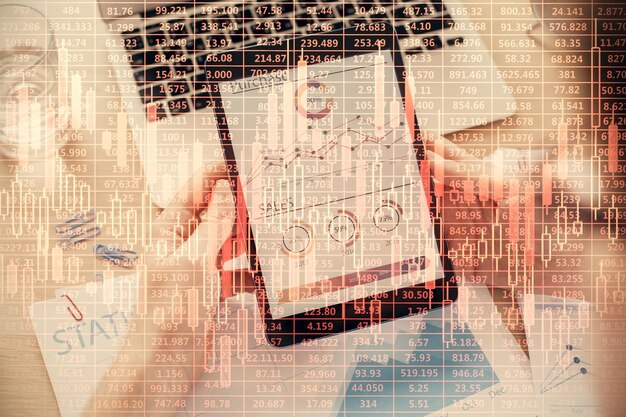 A close-up view of a calculator and financial newspaper featuring REIT stock quotes, emphasizing the importance of financial analysis in REIT investing.