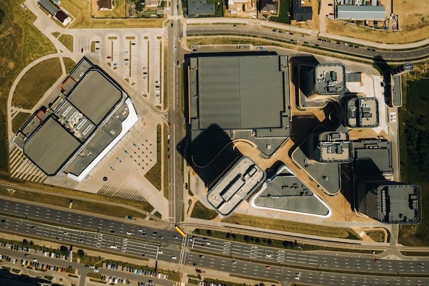 An aerial view of a large industrial park with multiple warehouses and distribution centers, showcasing the scale and diversity of industrial REIT investments.