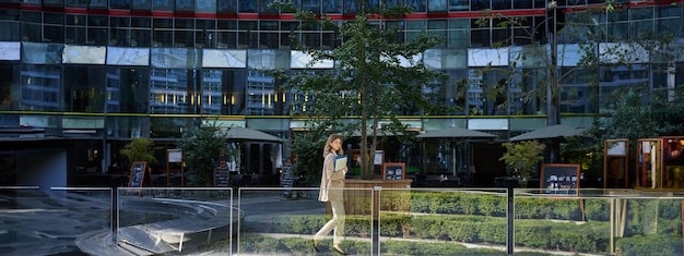 A modern office building in an Opportunity Zone, with solar panels on the roof and a sign indicating it is a 